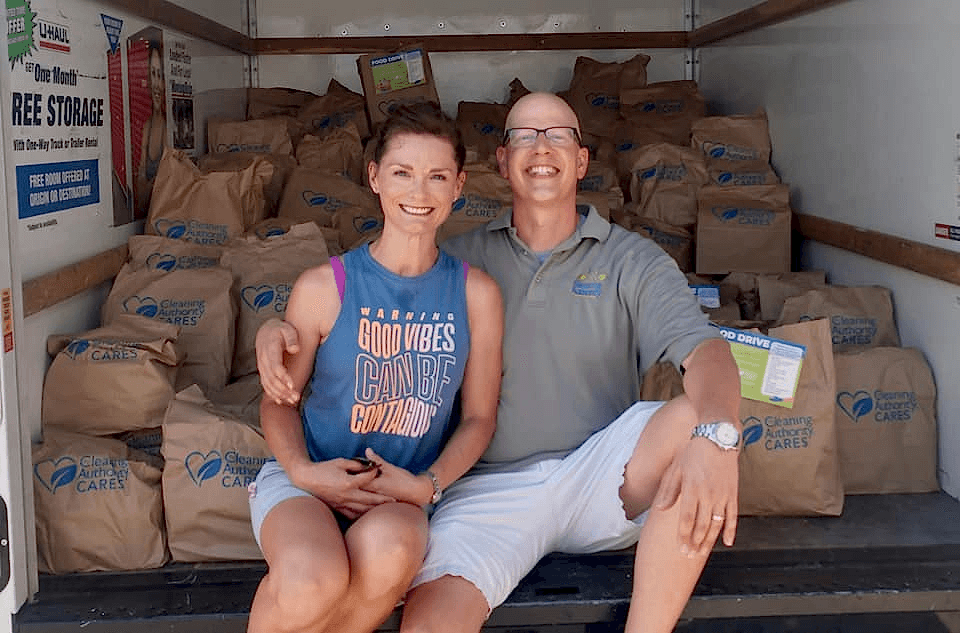 Image of two people infront of Donation Bags