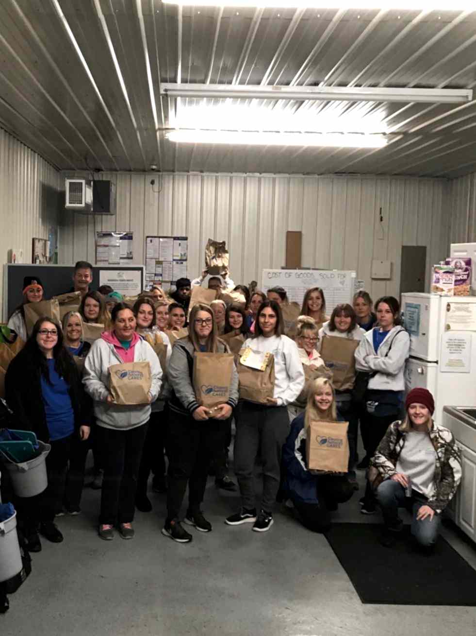 The TCA Cincinnati team poses with the food donations collected for local charities.