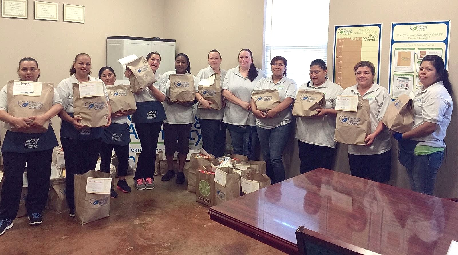 The TCA Tyler team poses in their offices with the donations they collected for a local charity.